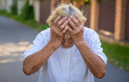 The old woman grandmother has a headache. Selective focus. Nature.の写真素材