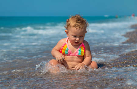 Child girl at the sea. Selective focus. Baby.の写真素材