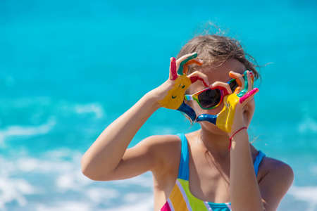 Child hands painted with paints on the sea. Selective focus. Kid.の写真素材