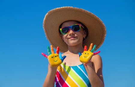 Child hands painted with paints on the sea. Selective focus. Kid.の写真素材