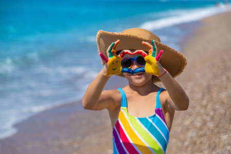 Child hands painted with paints on the sea. Selective focus. Kid.の写真素材