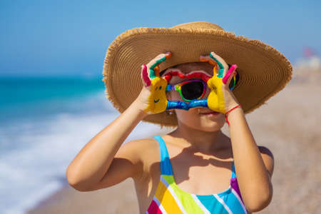Child hands painted with paints on the sea. Selective focus. Kid.の写真素材