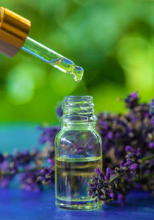 Lavender essential oil in a bottle. Selective focus. Nature.の写真素材