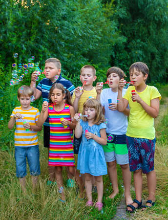 Children blow bubbles in the street. Selective focus. nature.の写真素材
