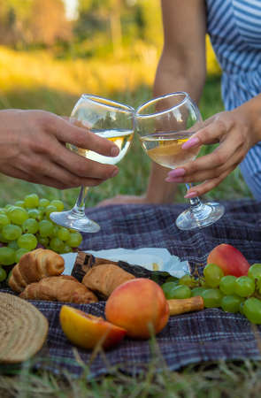 A man and a woman are drinking wine at a picnic. Selective focus. Nature.の写真素材