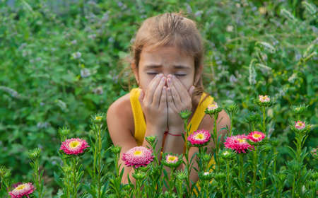 The child is seasonal allergy to flowers. Selective focus. Kid.の写真素材