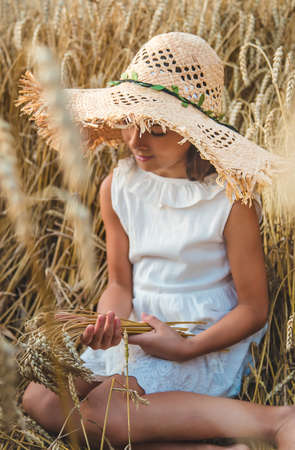 A child in a wheat field. Selective focus. Nature.の写真素材