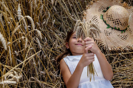 A child in a wheat field. Selective focus. Nature.の写真素材
