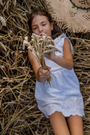 A child in a wheat field. Selective focus. Nature.の写真素材