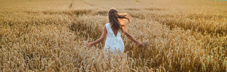A child in a wheat field. Selective focus. Nature.の写真素材