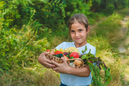 The child holds vegetables in his hands. Selective focus. Kid.の写真素材