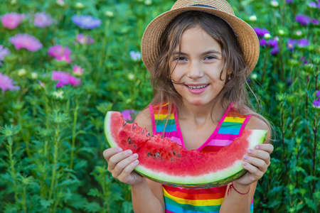 The child eats watermelon in the summer. Selective focus. Baby.の写真素材