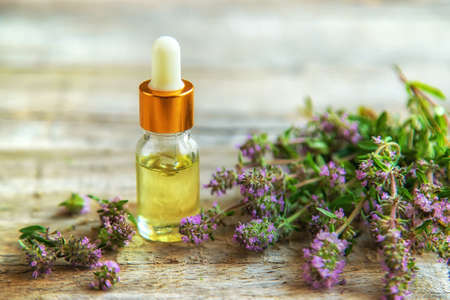 Thyme essential oil in a small bottle. Selective focus. Nature.の写真素材