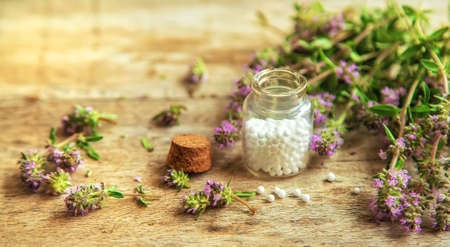 Thyme essential oil in a small bottle. Selective focus. Nature.の写真素材