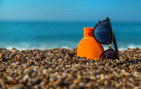 Sunscreen and glasses on the beach. Selective focus. Travel.の写真素材