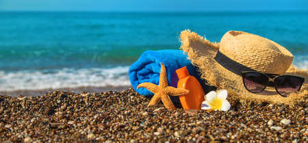 Sunscreen and glasses on the beach. Selective focus. Travel.の写真素材