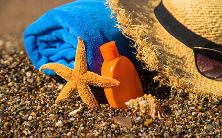 Sunscreen and glasses on the beach. Selective focus. Travel.の写真素材