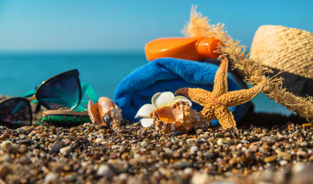 Sunscreen and glasses on the beach. Selective focus. Travel.の写真素材