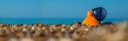 Sunscreen and glasses on the beach. Selective focus. Travel.の写真素材