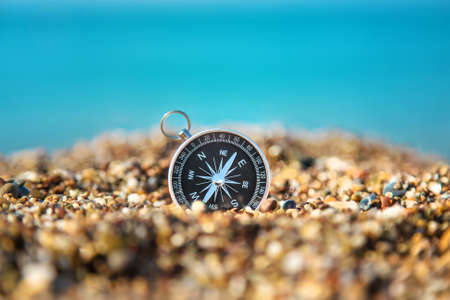 Compass on the sea beach. Selective focus. Travel.の写真素材