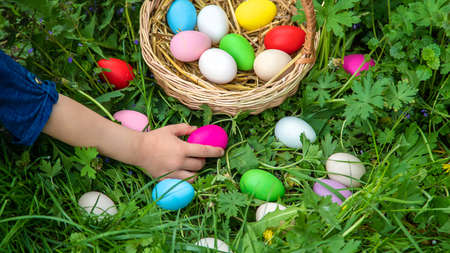 The child holds Easter eggs in his hands. Selective focus. Kid.