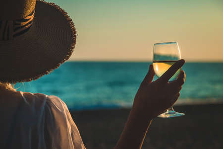 Wine glasses at sunset on the beach. Selective focus. Nature.の写真素材
