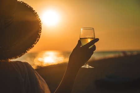 Wine glasses at sunset on the beach. Selective focus. Nature.の写真素材