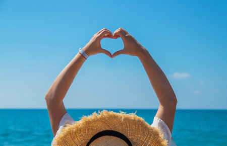 Woman with hat on the beach. Selective focus. Sea.の写真素材