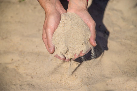 Sand quarry in the hands of a man. Selective focus. Nature.の写真素材