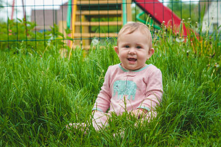 Baby is lying on the grass. Selective focus. Nature.の写真素材