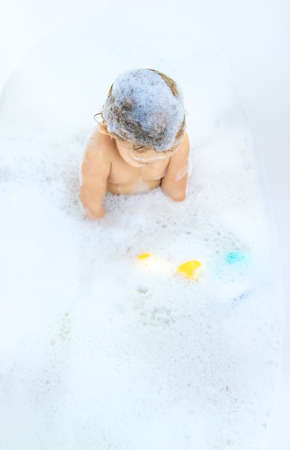 A child bathes in a bubble bath. selective focus. Happy.の写真素材