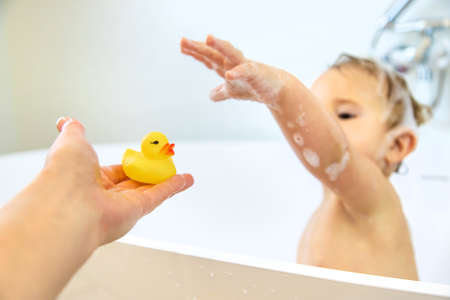 A child bathes in a bubble bath. selective focus. Happy.の写真素材