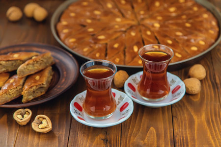 Baklava on the table and tea in Turkish glasses. Selective focus.の写真素材