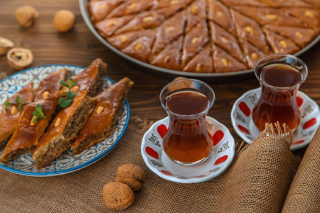 Baklava on the table and tea in Turkish glasses. Selective focus.の写真素材