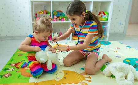 Children play together treat the bear. selective focus. kids.の写真素材