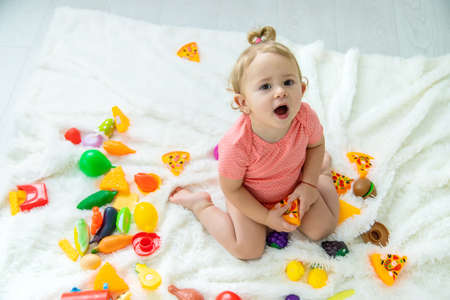 Baby plays with toys in her room. selective focus. child.