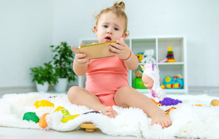 Baby is playing on the phone. selective focus. kid.