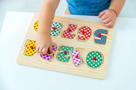 The child learns numbers at the table. selective focus. kid.