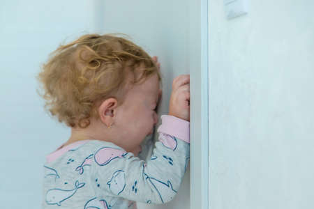 Baby cries closed the door. selective focus. child.の写真素材