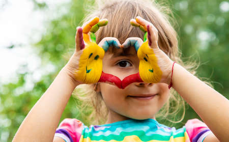 Children's hands with smile paints. selective focus. people.の写真素材