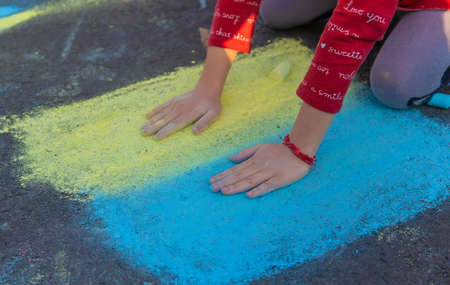 Children draw the flag of Ukraine. Selective focus.の写真素材