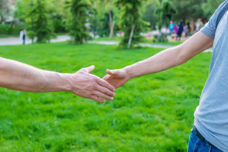 Handshake of men at a meeting in the park. selective focus. people.の写真素材