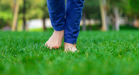 Children's feet go on the grass. selective focus. people.
