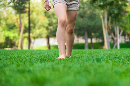 Children's feet go on the grass. selective focus. people.