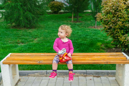 The child eats chips in the park. selective focus. kid.の写真素材