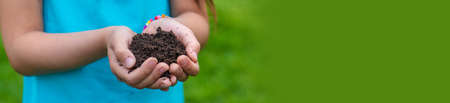 The child holds the soil in his hands. selective focus. kid.