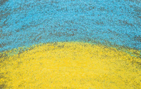 Children draw the Ukrainian flag on the pavement. selective focus. Nature.