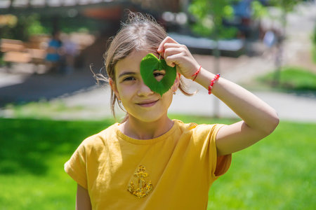 The child is holding a tree in his hands. selective focus. Nature.の写真素材