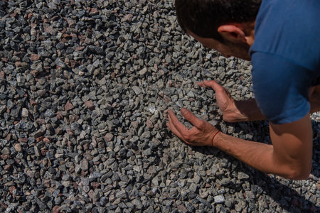 Crushed stones in the hands of a man. selective focus. Nature.