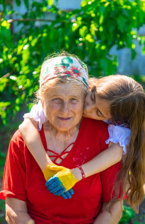 Child and grandmother hand drawn flag of Ukraine. Selective focus.の写真素材